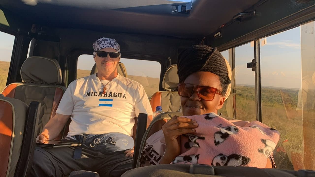 Travellers relaxing inside the safari vehicle at golden hour